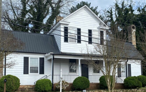 Warrenton apartment for rent - A white house with a black roof and a chimney.