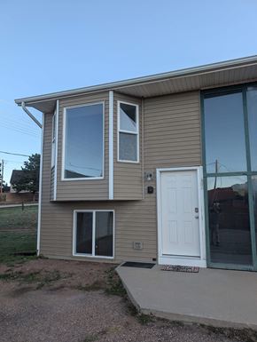 Woodland Park apartment for rent - A house with a white door and windows.
