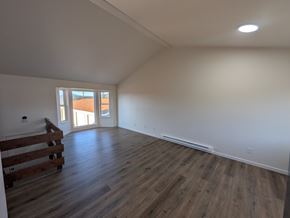 Woodland Park apartment for rent - A room with wooden floors and a window.