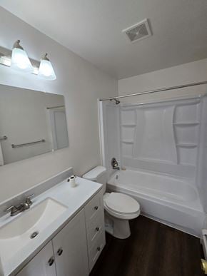 Woodland Park apartment for rent - A white bathroom with a toilet, sink, and bathtub.