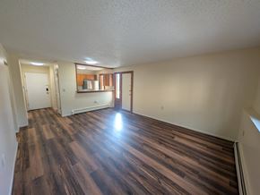 Woodland Park apartment for rent - A room with wooden flooring and a white ceiling.