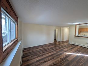 Woodland Park apartment for rent - A room with wooden flooring and a large window on the left side.
