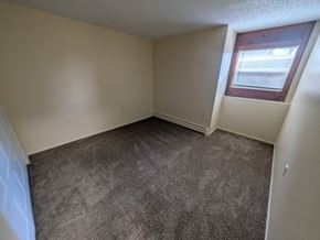 Woodland Park apartment for rent - A room with a carpeted floor and a window with blinds.