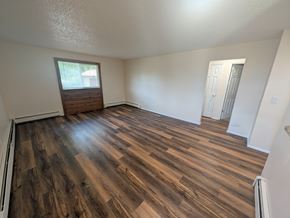 Woodland Park apartment for rent - A room with wooden flooring and a window.