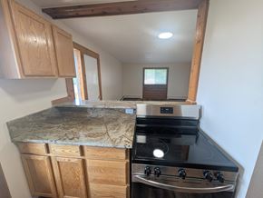 Woodland Park apartment for rent - A kitchen with a granite countertop and a stainless steel oven.