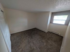 Woodland Park apartment for rent - A room with a carpeted floor and a window.