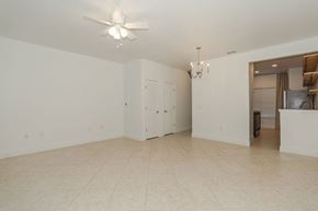Freeport house for rent - A spacious room with a ceiling fan and a chandelier.