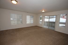 Whitefish apartment for rent - A room with carpeted floor and three windows.