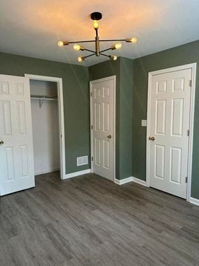 Gary house for rent - A room with a chandelier and three doors.