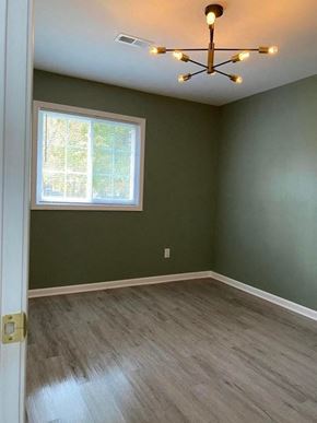 Gary house for rent - A room with a window and a chandelier.
