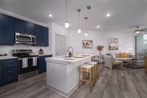 Huntsville apartment for rent - A modern kitchen with dark blue cabinets and a white island.