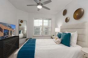 Huntsville apartment for rent - A bedroom with a large bed and a flat screen TV.