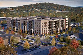 Huntsville apartment for rent - A large building with a parking lot in front of it.