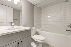 Spruce Grove apartment for rent - A white bathroom with a toilet, sink, and bathtub.