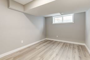Spruce Grove apartment for rent - A room with a window and wooden flooring.