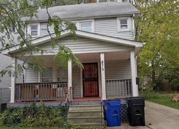Cleveland house for rent - A house with a porch and two trash bins in front.