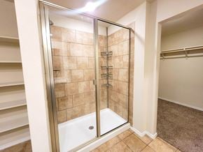 Killeen house for rent - A walk-in shower with a glass door and a white tub.