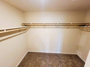 Killeen house for rent - Empty room with a carpeted floor and two shelves.