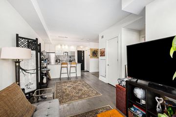 Ottawa apartment for rent - A living room with a grey couch and a brown pillow.