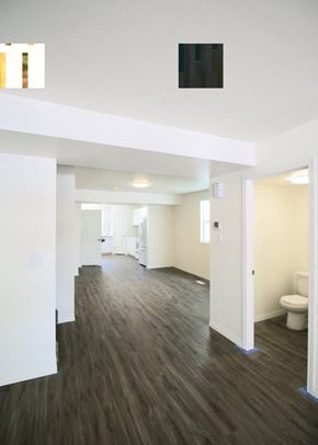Edmonton apartment for rent - A long hallway with wood floors and white walls.