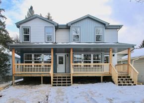 Edmonton apartment for rent - A house with a grey roof and a white door.