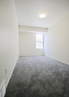 Edmonton apartment for rent - A room with a carpeted floor and a window.