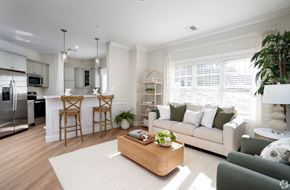 Derry apartment for rent - A modern kitchen with a breakfast bar and a living room with a couch.