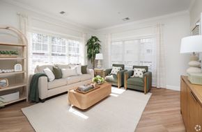 Derry apartment for rent - A living room with a white couch, a green armchair, and a wooden coffee table.