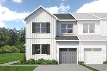 Berlin house for rent - A two-story house with a white exterior and a grey garage door.