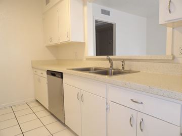 Dallas apartment for rent - A kitchen with white cabinets and a sink.