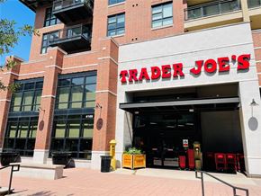 Dallas apartment for rent - A Trader Joe's storefront with a red brick building and a black awning.