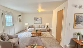 Wheat Ridge apartment for rent - A brick building with a green roof and two white doors.