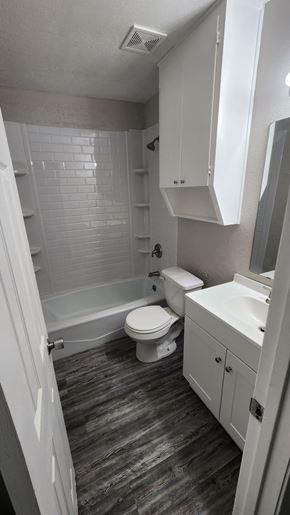 Copperas Cove apartment for rent - A white bathroom with a toilet, sink, and shower.