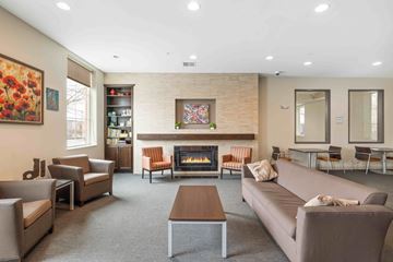 Denver apartment for rent - A living room with a fireplace and a painting on the wall.