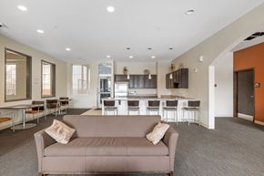 Denver apartment for rent - A living room with a couch and a dining table.