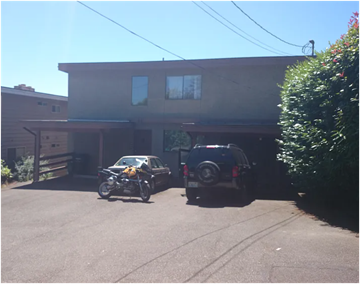 Seattle apartment for rent - A motorcycle is parked in front of a house.