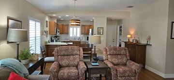 Sarasota house for rent - Two floral patterned chairs are in the middle of a living room.