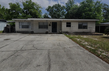Jacksonville apartment for rent - A small brick building with a parking lot in front.
