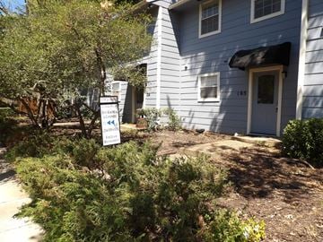 Dallas apartment for rent - A blue house with a sign that says "For Sale" in front of it.