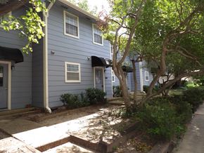 Dallas apartment for rent - A tree in front of a blue house.
