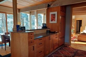 Boulder house for rent - A kitchen with wooden cabinets and a large window.