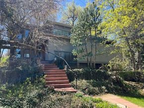 Boulder house for rent - A house with a staircase leading to the front door.
