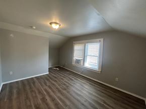 Louisville apartment for rent - A room with wooden flooring and a window with blinds.