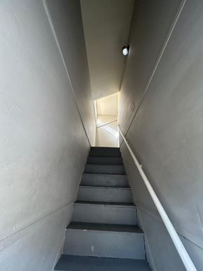 Louisville apartment for rent - A stairway with a light at the top.