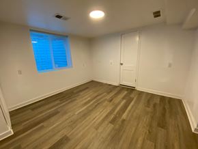 Louisville apartment for rent - A room with wooden flooring and a window with blinds.