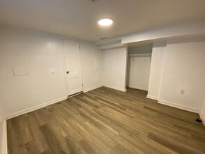 Louisville apartment for rent - A room with wooden flooring and white walls.