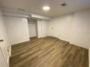 Louisville apartment for rent - A room with wooden flooring and white walls.
