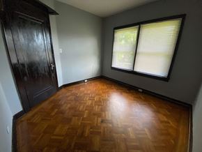 Louisville apartment for rent - A room with a wooden floor and a window with blinds.