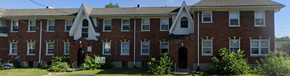 Louisville apartment for rent - A red brick building with white trim and a black door.