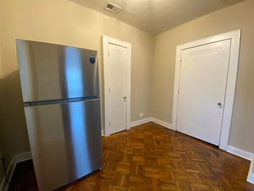 Louisville apartment for rent - A kitchen with a stainless steel refrigerator and wooden floors.